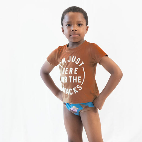 a boy on a white backdrop modeling a brown shirt and brief style underwear with ice cream on it