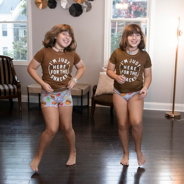 two twin girls dancing in their underwear